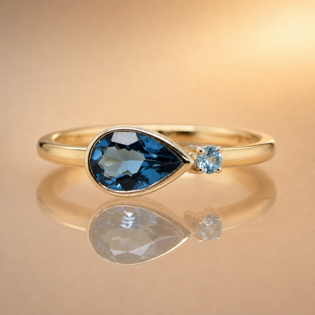 Gold ring with blue gemstones on a beige background